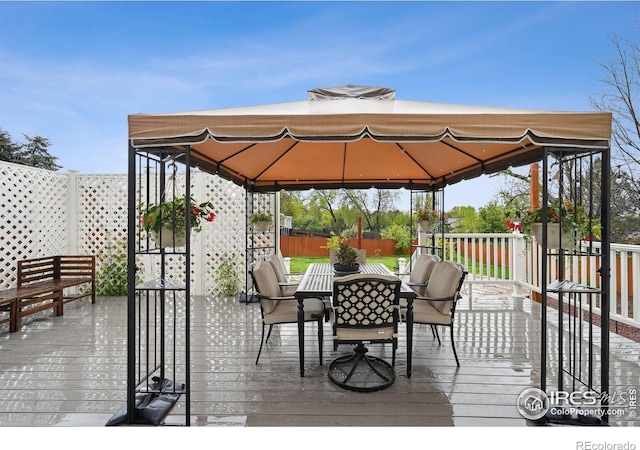 13106 Elizabeth St, Thornton, CO 80241 - wooden terrace with a gazebo, outdoor dining space, and fence