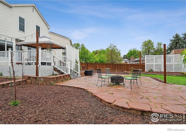 13106 Elizabeth St, Thornton, CO 80241 - view of patio / terrace featuring an outdoor fire pit, a gazebo, and fence
