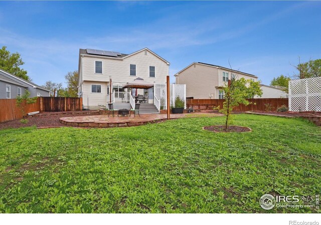 13106 Elizabeth St, Thornton, CO 80241 - back of property with a gazebo, solar panels, a deck, and a patio