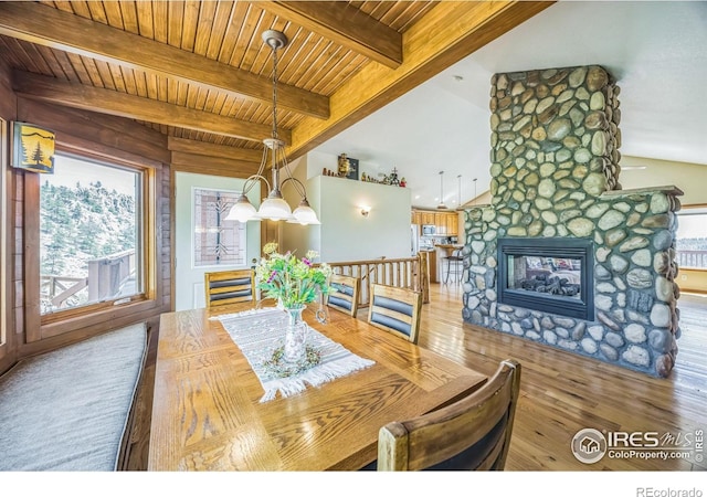 117 Mount Sherman Ct, Livermore, CO 80536 - dining room featuring wood ceiling, wood finished floors, and a stone fireplace