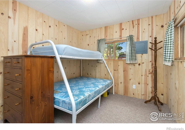 carpeted bedroom with wooden walls