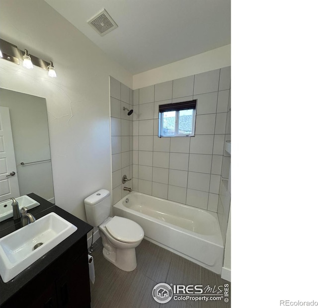 bathroom featuring bathing tub / shower combination, toilet, tile patterned floors, and vanity