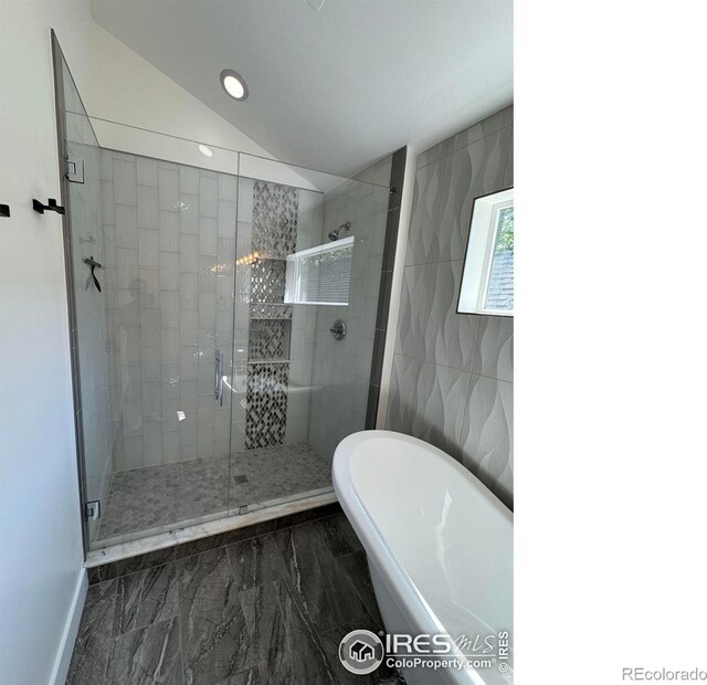 full bathroom featuring marble finish flooring, a soaking tub, a shower stall, vaulted ceiling, and recessed lighting