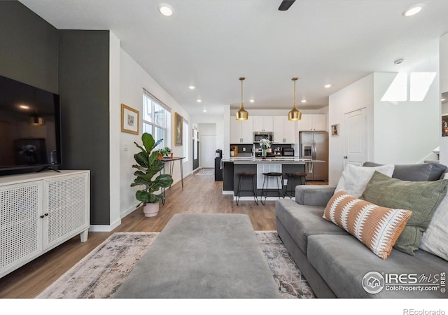 700 Lillibrook Pl, Erie, CO 80026 - living room featuring light wood-style flooring, recessed lighting, and baseboards