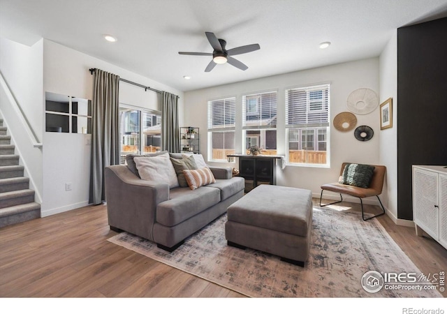 700 Lillibrook Pl, Erie, CO 80026 - living room with wood finished floors, ceiling fan, stairway, baseboards, and recessed lighting