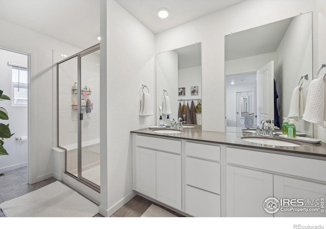 700 Lillibrook Pl, Erie, CO 80026 - full bath with a stall shower, double vanity, and baseboards