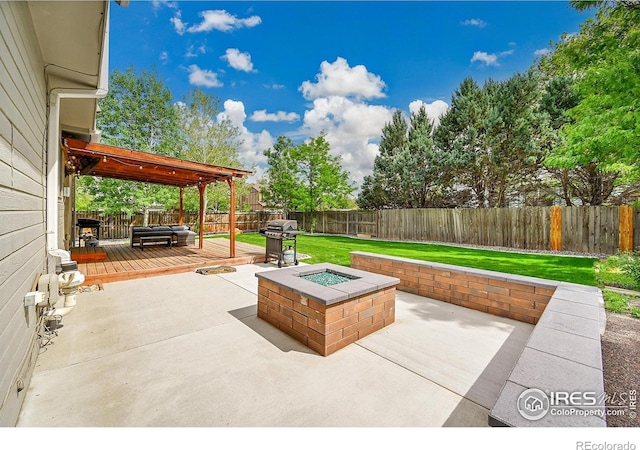 view of patio / terrace with an outdoor fire pit, a wooden deck, and area for grilling