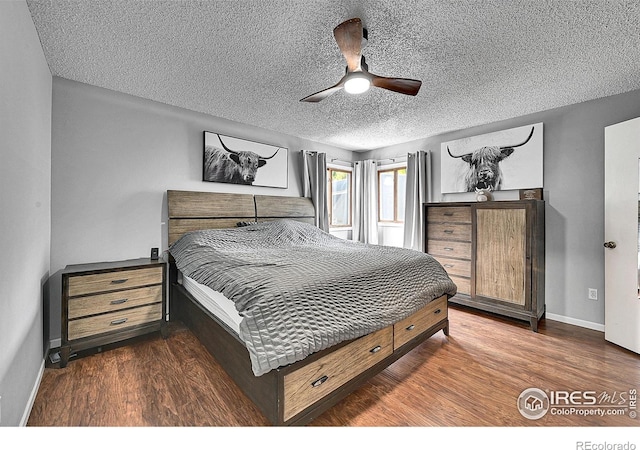 bedroom featuring baseboards, a textured ceiling, wood finished floors, and a ceiling fan