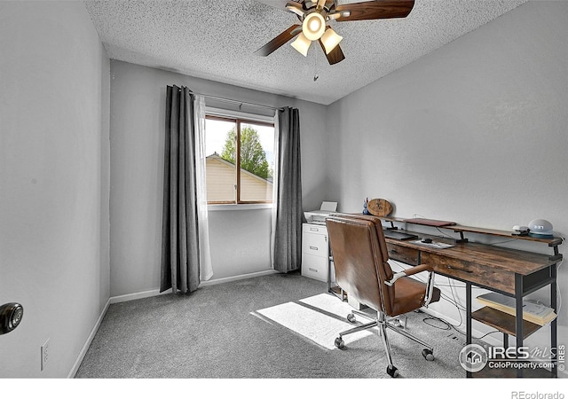 office area with a textured ceiling, a ceiling fan, light carpet, and baseboards