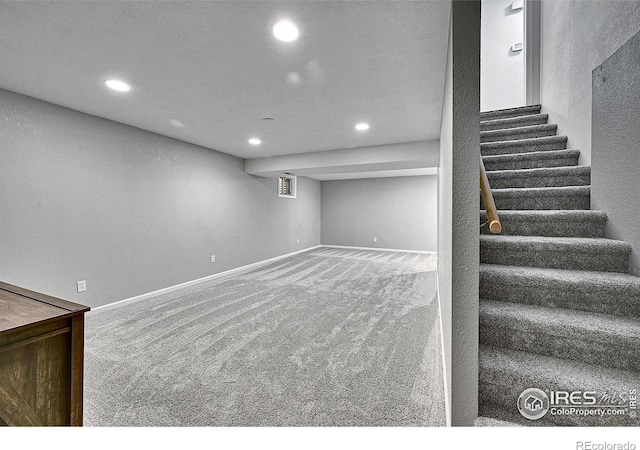 finished below grade area featuring recessed lighting, carpet floors, stairs, and baseboards