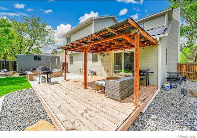 wooden terrace featuring fence, grilling area, and a patio