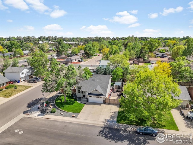 aerial view of residential area featuring a tree filled landscape