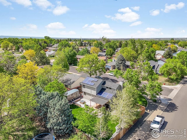 aerial view of residential area featuring a tree filled landscape