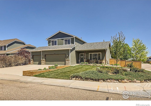 6601 Viburnum St, Wellington, CO 80549 - view of front of property with stone siding, driveway, an attached garage, and covered porch