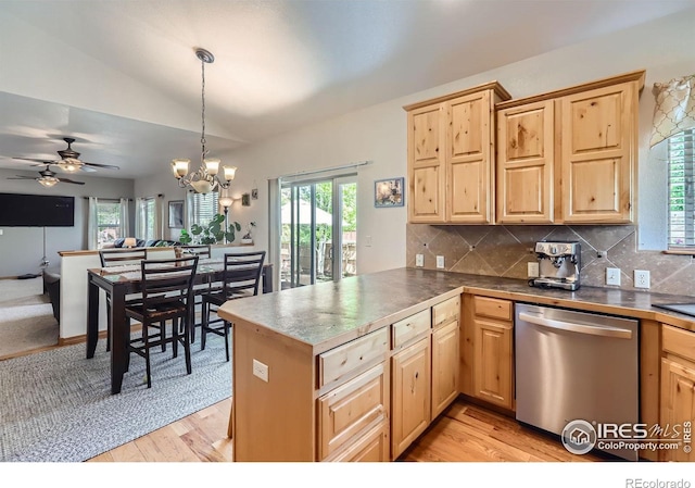 6601 Viburnum St, Wellington, CO 80549 - kitchen with stainless steel dishwasher, light brown cabinets, light wood-style floors, lofted ceiling, and healthy amount of natural light