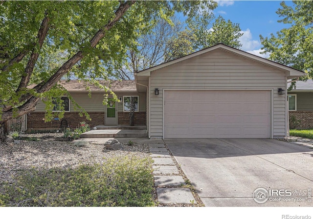 2310 44th Ave, Greeley, CO 80634 - ranch-style home featuring an attached garage, driveway, and brick siding