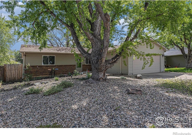 2310 44th Ave, Greeley, CO 80634 - single story home with fence, brick siding, concrete driveway, and an attached garage