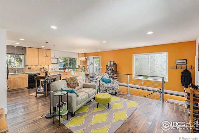 2310 44th Ave, Greeley, CO 80634 - living room featuring recessed lighting, wood-type flooring, and baseboards