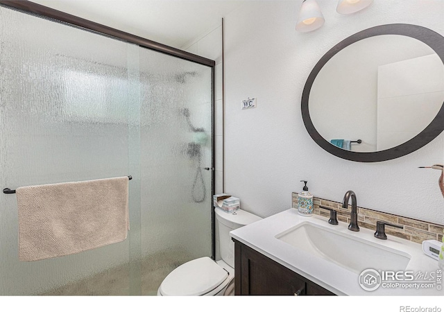 2310 44th Ave, Greeley, CO 80634 - bathroom featuring toilet, a stall shower, and vanity