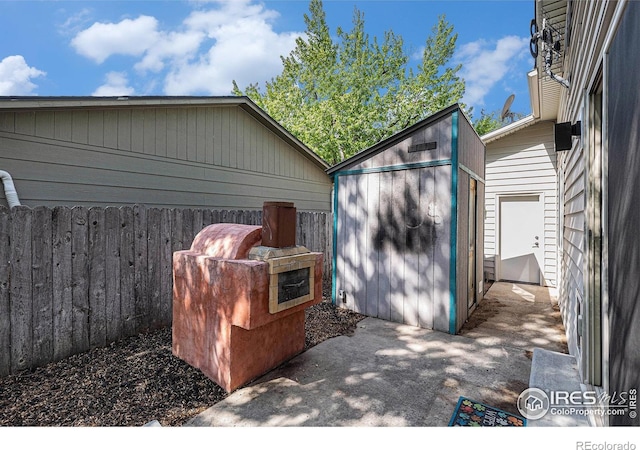 2310 44th Ave, Greeley, CO 80634 - garage featuring a storage shed and fence