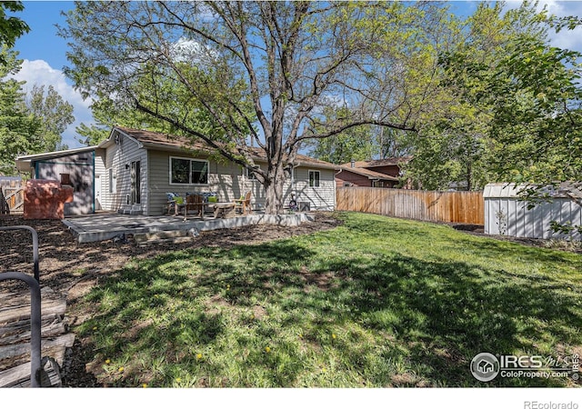2310 44th Ave, Greeley, CO 80634 - view of yard featuring a storage unit, an outdoor structure, and a wooden deck