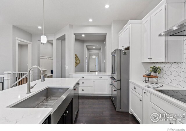 4843 Mariana Hills Cir, Loveland, CO 80537 - kitchen with appliances with stainless steel finishes, a sink, dark wood-style flooring, white cabinetry, and recessed lighting