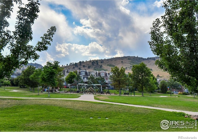 view of community with a yard and a mountain view