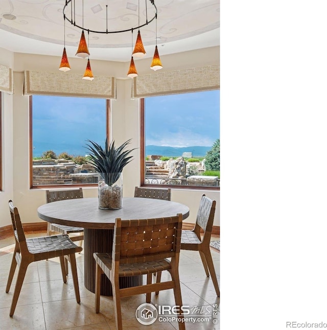 dining area with light tile patterned flooring and baseboards