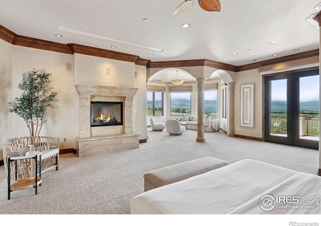 bedroom with carpet, access to outside, crown molding, baseboards, and a high end fireplace