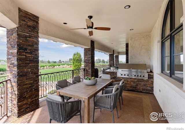 view of patio featuring area for grilling, exterior kitchen, outdoor dining space, and ceiling fan