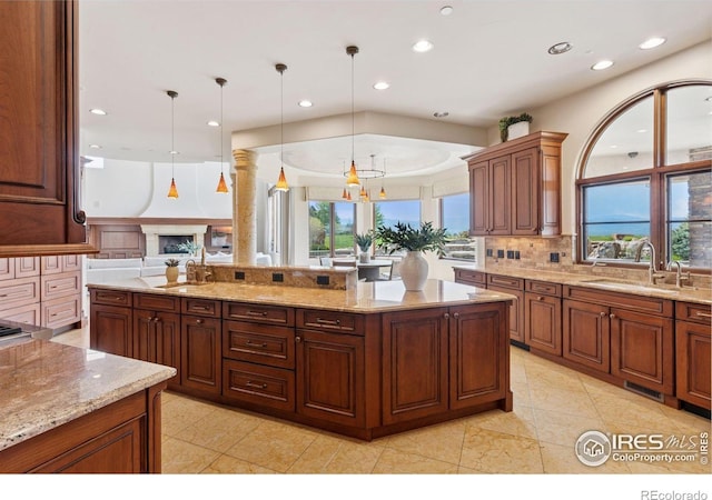kitchen featuring a sink, recessed lighting, decorative backsplash, and decorative light fixtures