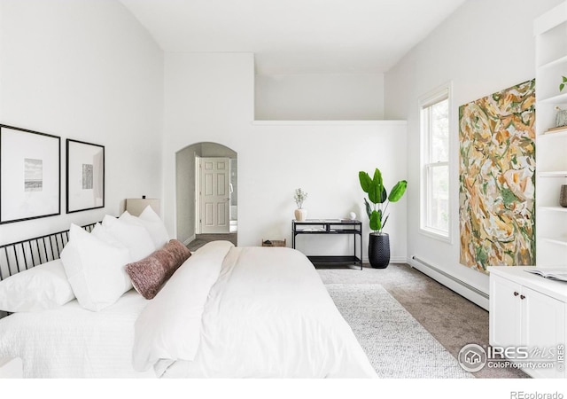 910 Kalmia Ave, Boulder, CO 80304 - bedroom featuring baseboard heating, carpet, arched walkways, and baseboards
