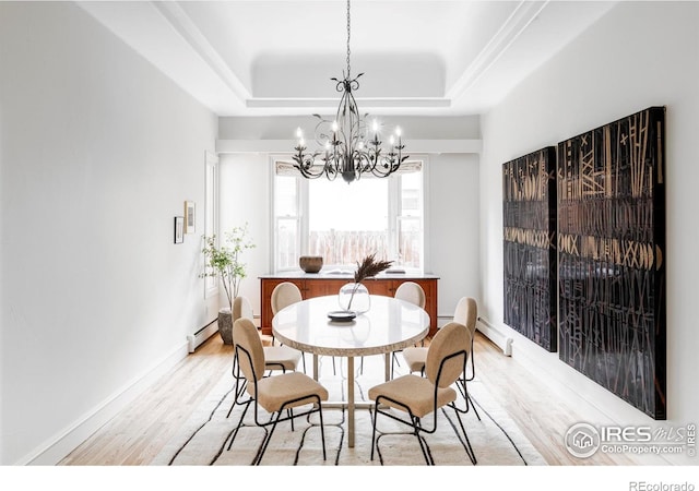 910 Kalmia Ave, Boulder, CO 80304 - dining area with light wood-style flooring, a chandelier, a baseboard heating unit, a tray ceiling, and baseboards