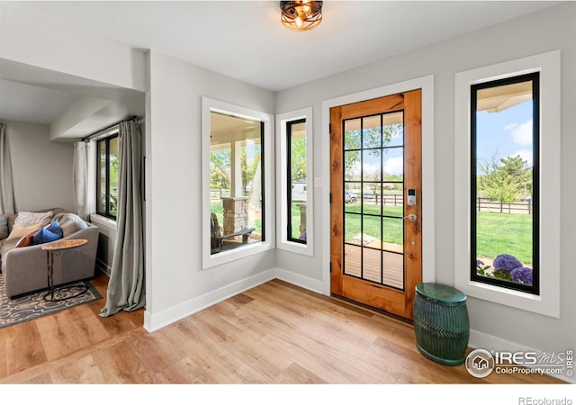 2017 Vaquero St, Longmont, CO 80504 - entryway with baseboards and light wood-style floors