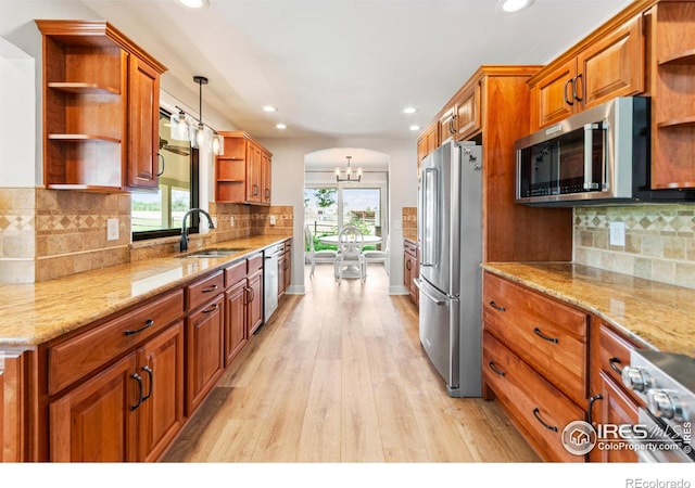 2017 Vaquero St, Longmont, CO 80504 - kitchen with open shelves, stainless steel appliances, a sink, light wood-style floors, and recessed lighting