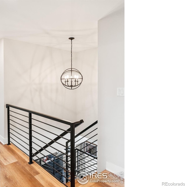 2017 Vaquero St, Longmont, CO 80504 - stairway with wood finished floors, a chandelier, and baseboards