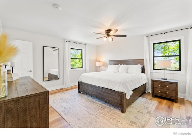 2017 Vaquero St, Longmont, CO 80504 - bedroom with light wood-style floors, baseboards, and a ceiling fan