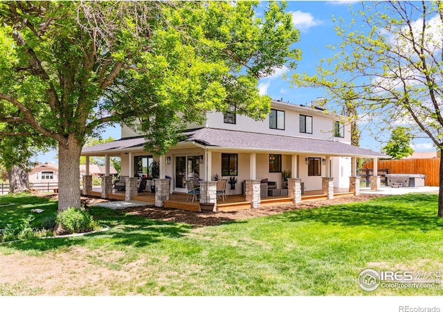 2017 Vaquero St, Longmont, CO 80504 - country-style home with stucco siding, a covered hot tub, outdoor lounge area, and a wooden deck