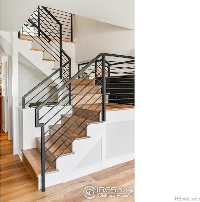 2017 Vaquero St, Longmont, CO 80504 - stairs with wood finished floors and baseboards