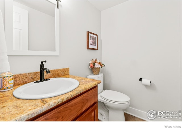 2017 Vaquero St, Longmont, CO 80504 - half bathroom featuring vanity, toilet, and baseboards