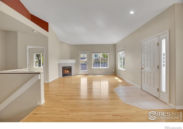 3742 Florentine Cir, Longmont, CO 80503 - unfurnished living room with light wood-type flooring, baseboards, a tile fireplace, and recessed lighting