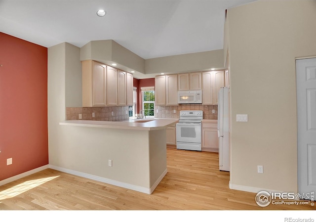 3742 Florentine Cir, Longmont, CO 80503 - kitchen with white appliances, light wood-style flooring, a peninsula, tasteful backsplash, and recessed lighting