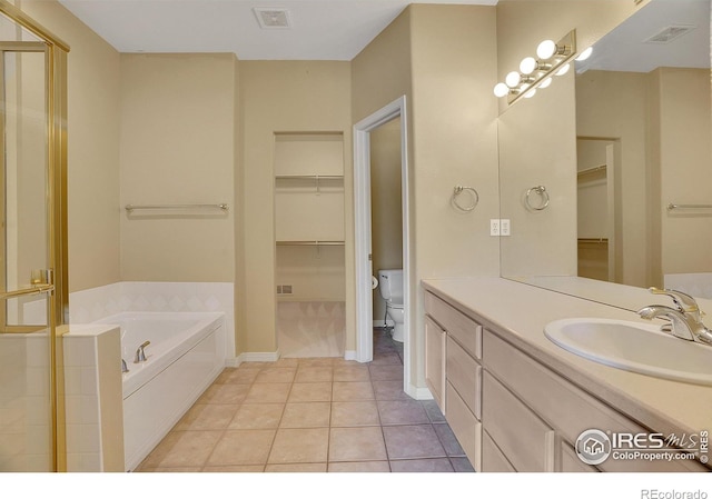 3742 Florentine Cir, Longmont, CO 80503 - bathroom with a garden tub, toilet, tile patterned flooring, vanity, and a shower with door