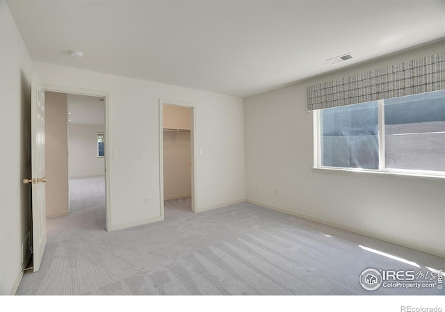 3742 Florentine Cir, Longmont, CO 80503 - unfurnished bedroom featuring light colored carpet, a spacious closet, and baseboards