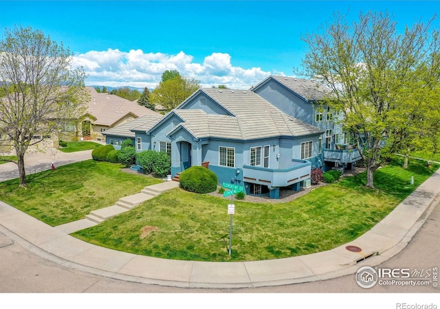 3742 Florentine Cir, Longmont, CO 80503 - view of front of home with a front yard, stucco siding, and a tiled roof