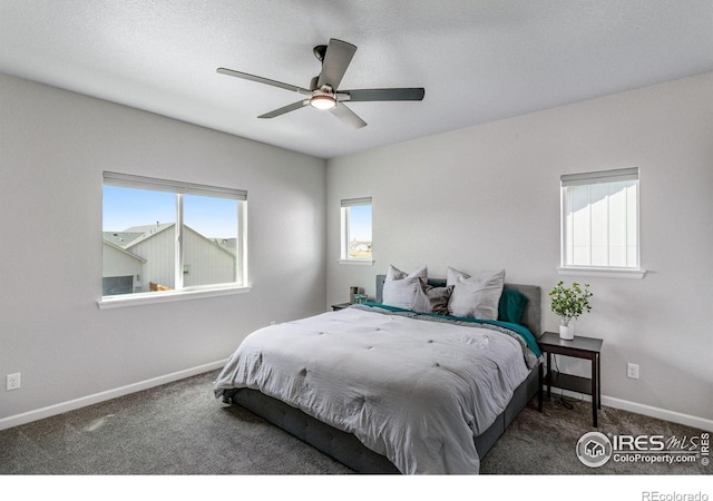 carpeted bedroom with multiple windows, baseboards, and ceiling fan