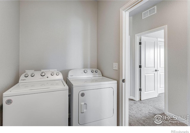 laundry room featuring separate washer and dryer and carpet flooring