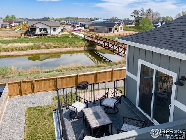 balcony featuring a water view and a residential view