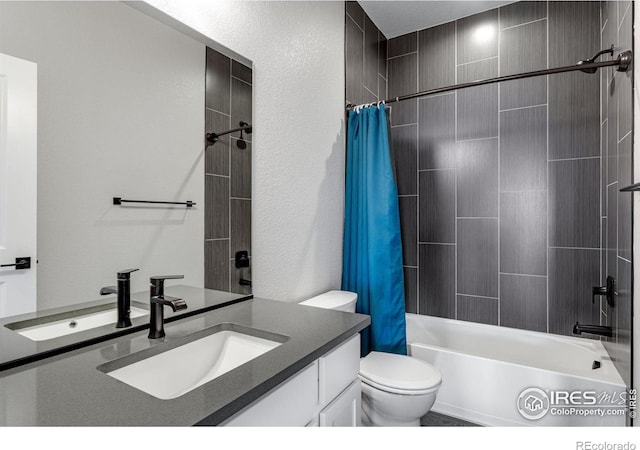 bathroom with shower / tub combo with curtain, toilet, and vanity