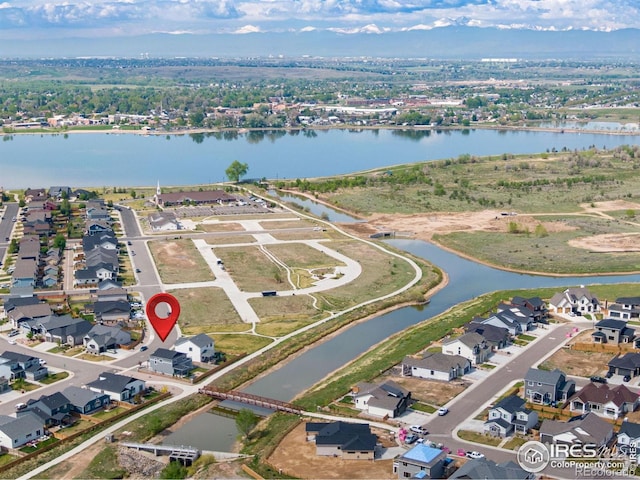 view of property location featuring a nearby body of water and nearby suburban area